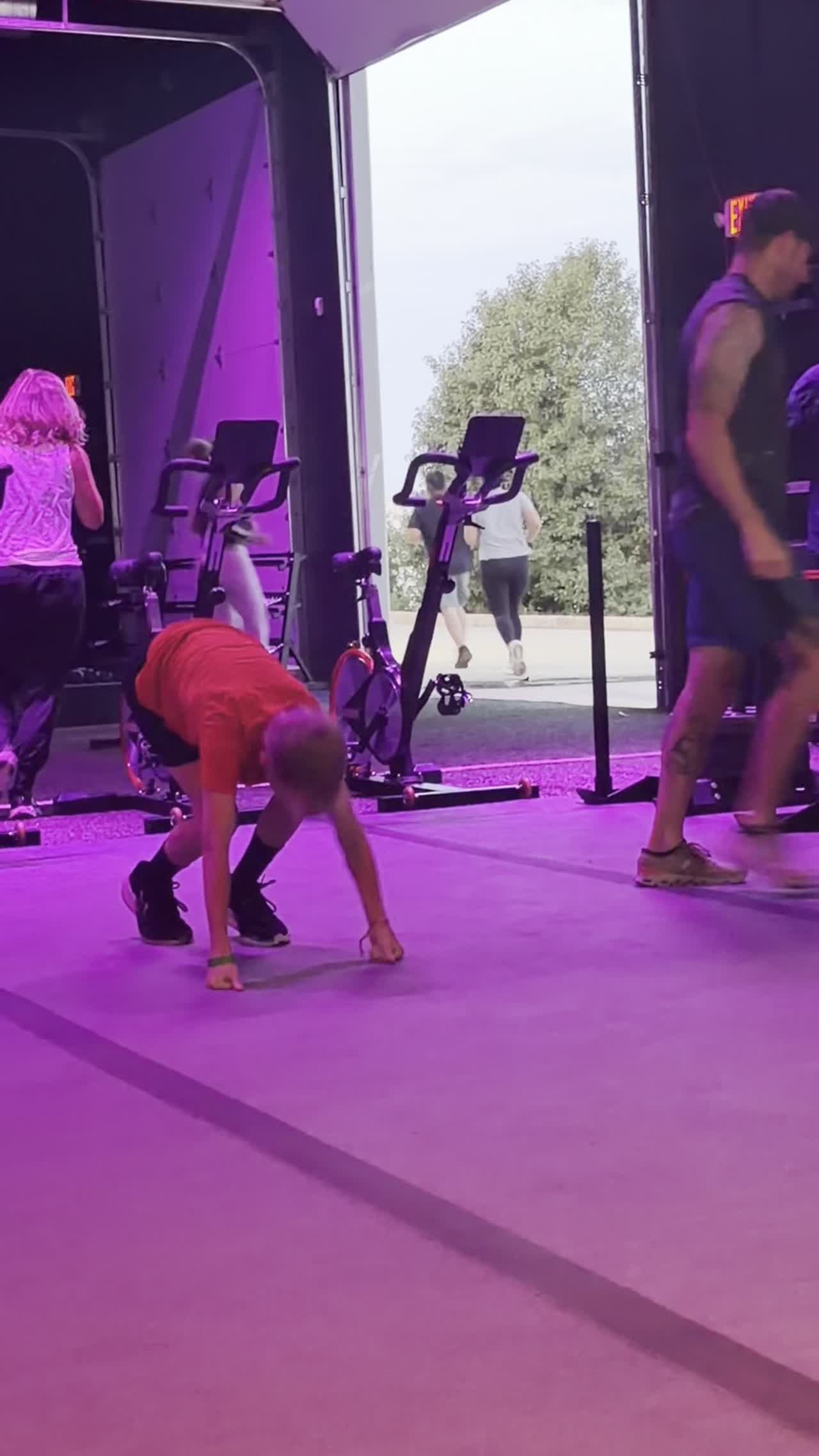 A kid bear-crawls across the training floor at Arize Training Club.